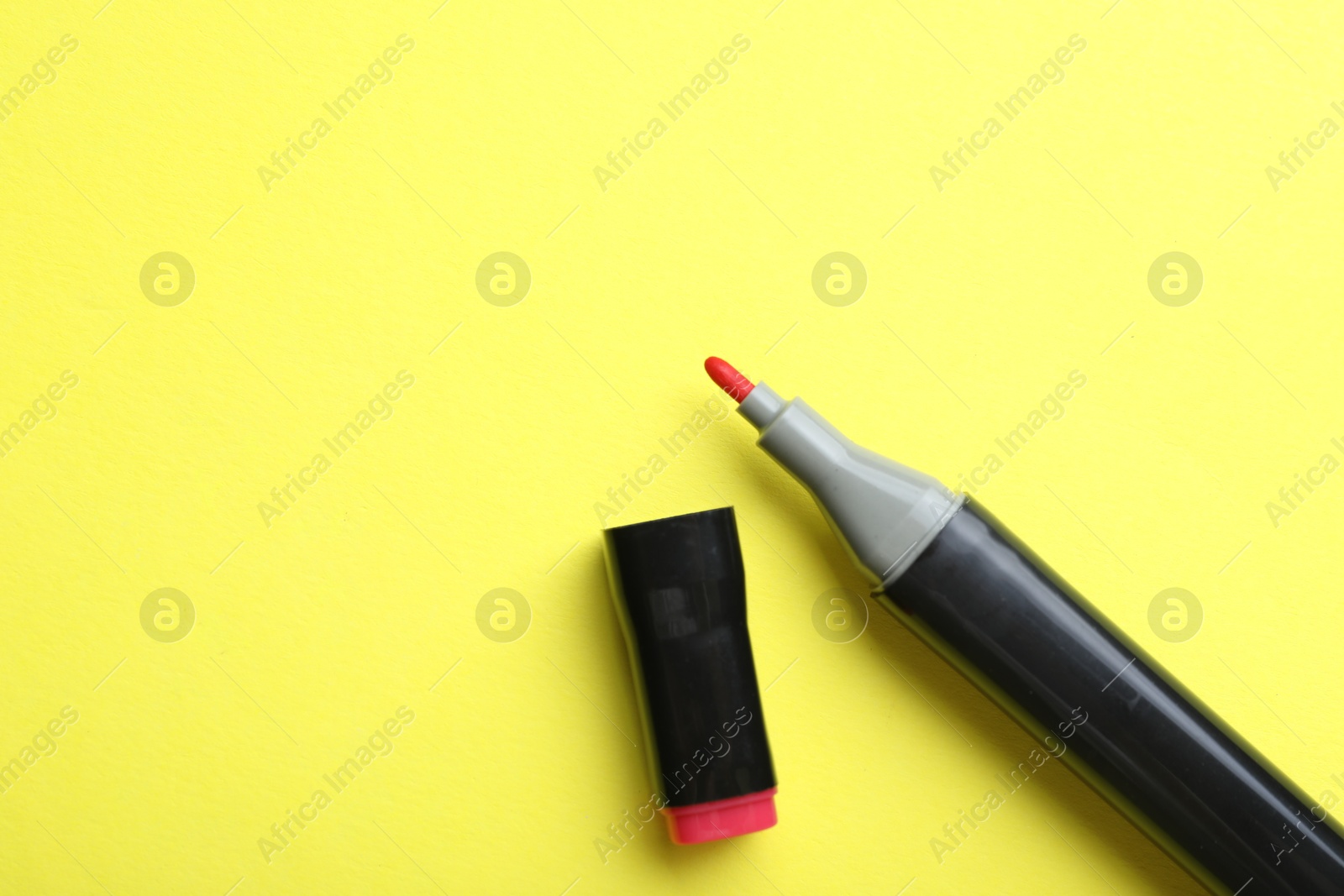 Photo of One color marker on yellow background, top view. Space for text