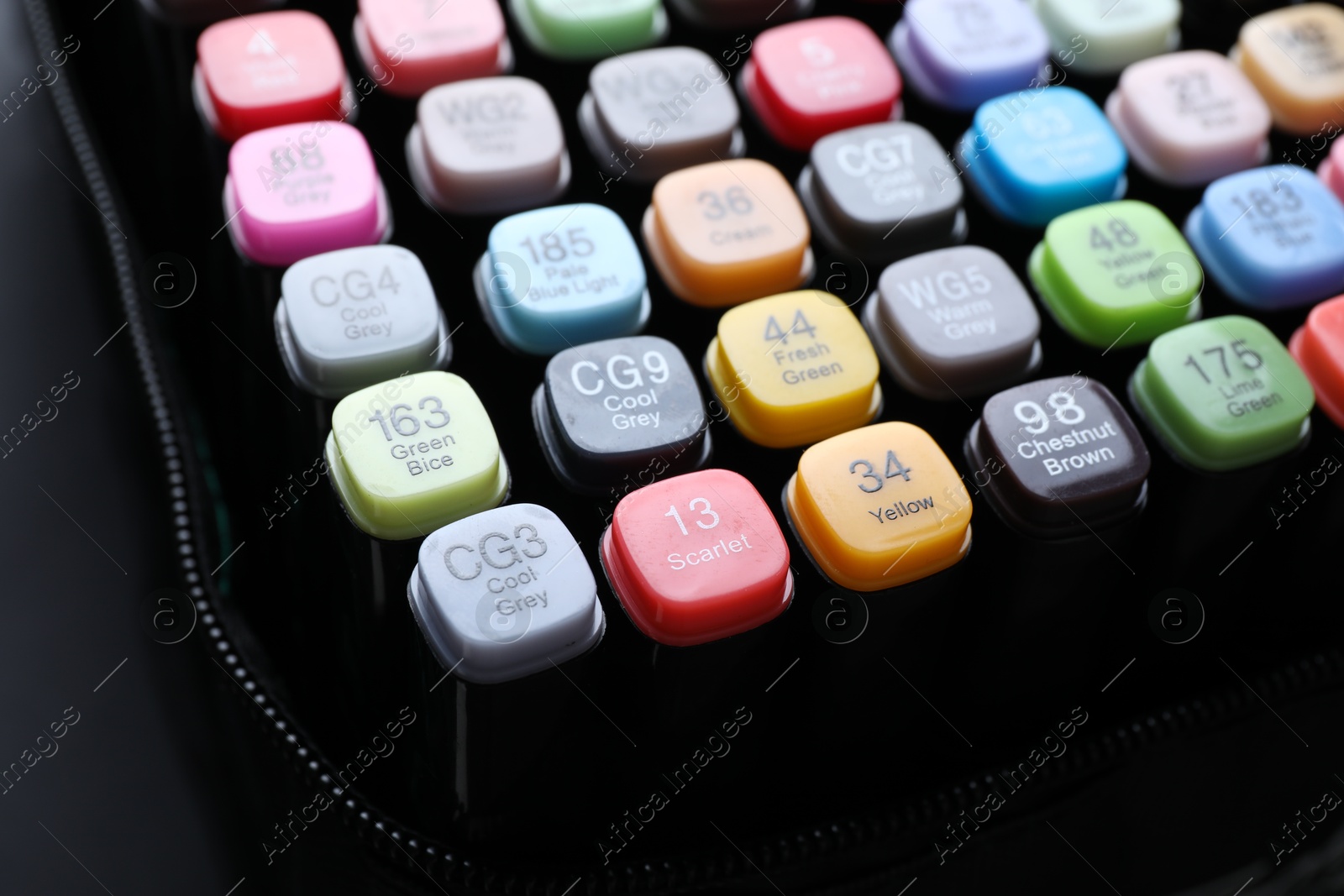 Photo of Different double sided markers on black background, closeup