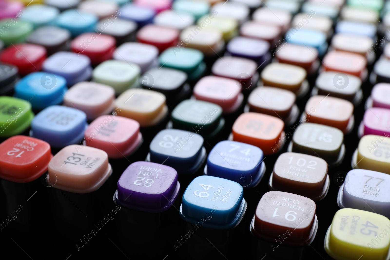 Photo of Different double sided markers on black background, closeup