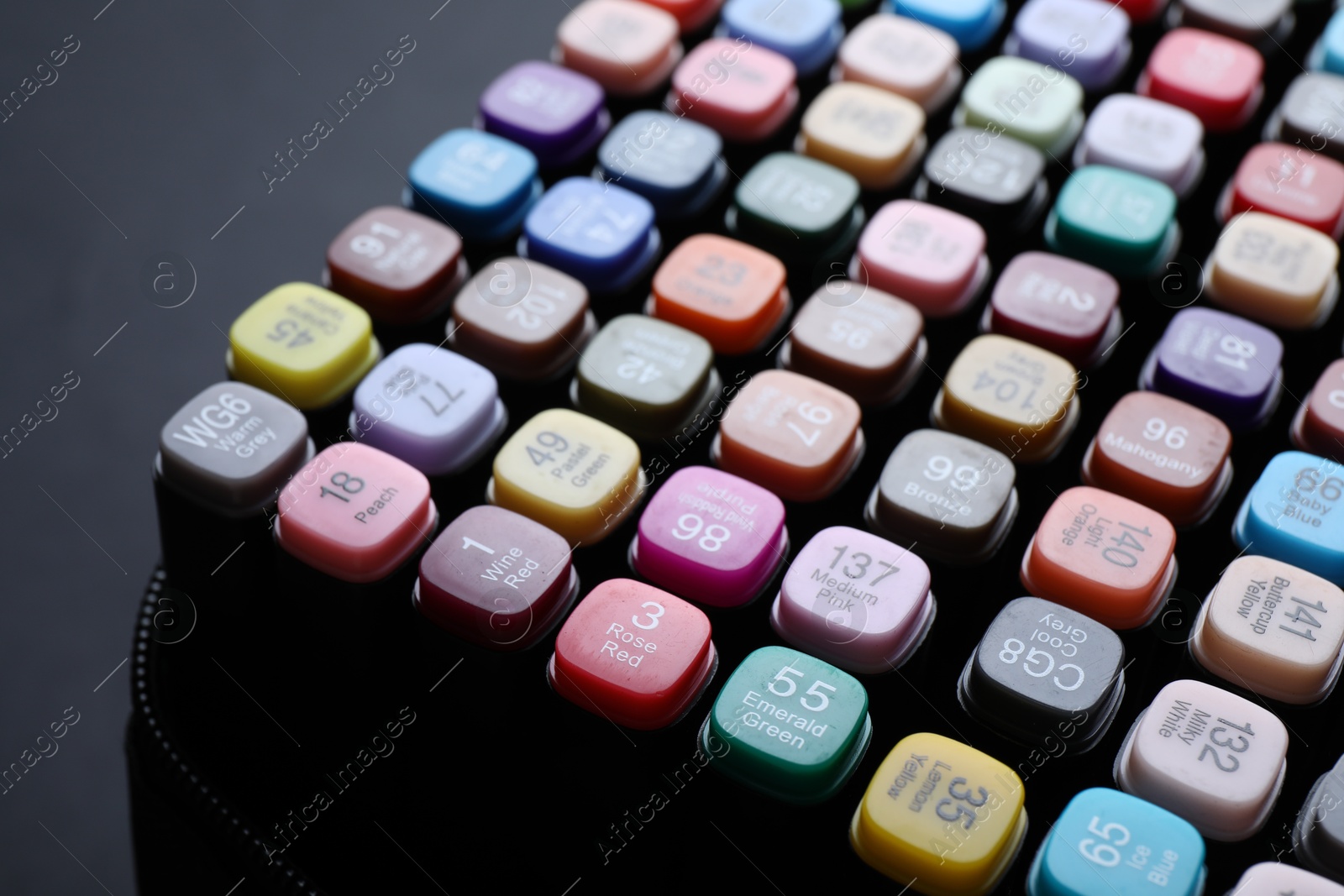 Photo of Different double sided markers on black background, closeup