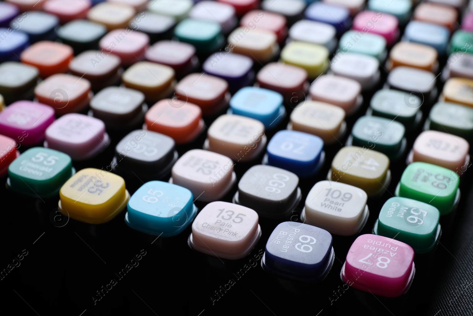 Photo of Different double sided markers on black background, closeup