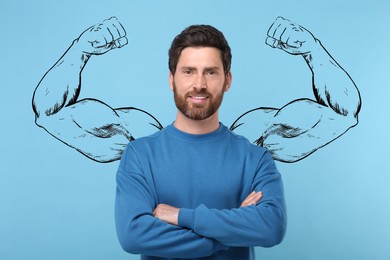 Image of Handsome man with drawing of strong arms behind him on light blue background