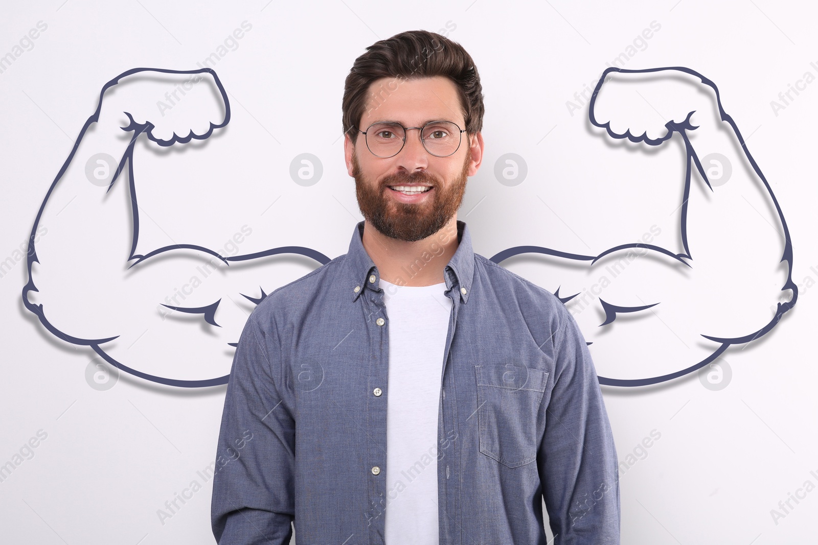 Image of Handsome man with drawing of strong arms behind him on white background