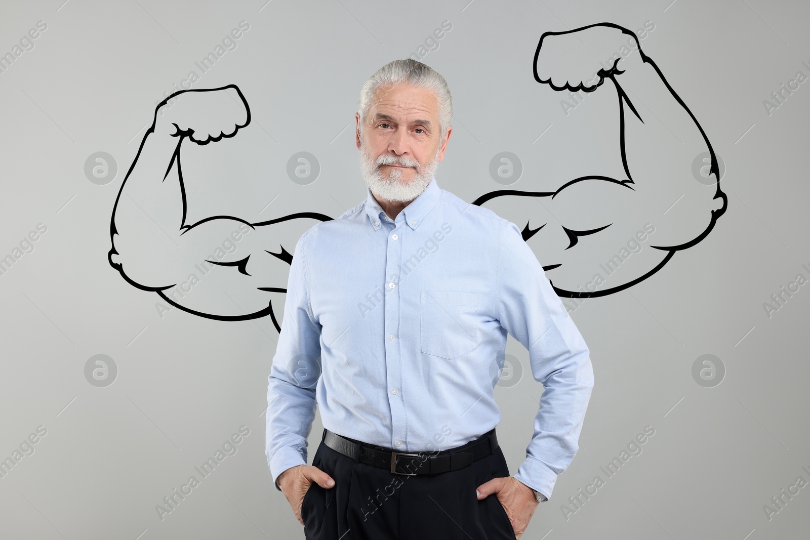 Image of Senior man with drawing of strong arms behind him on grey background