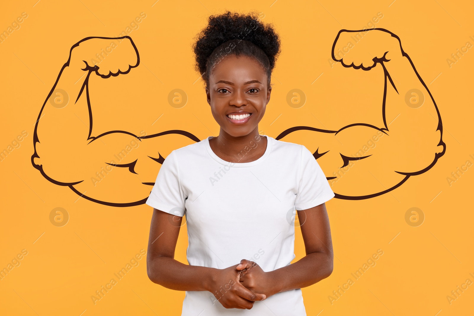 Image of Beautiful young woman with drawing of strong arms behind her on orange background