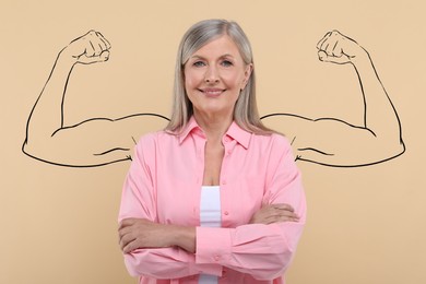 Image of Beautiful mature woman with drawing of strong arms behind her on beige background