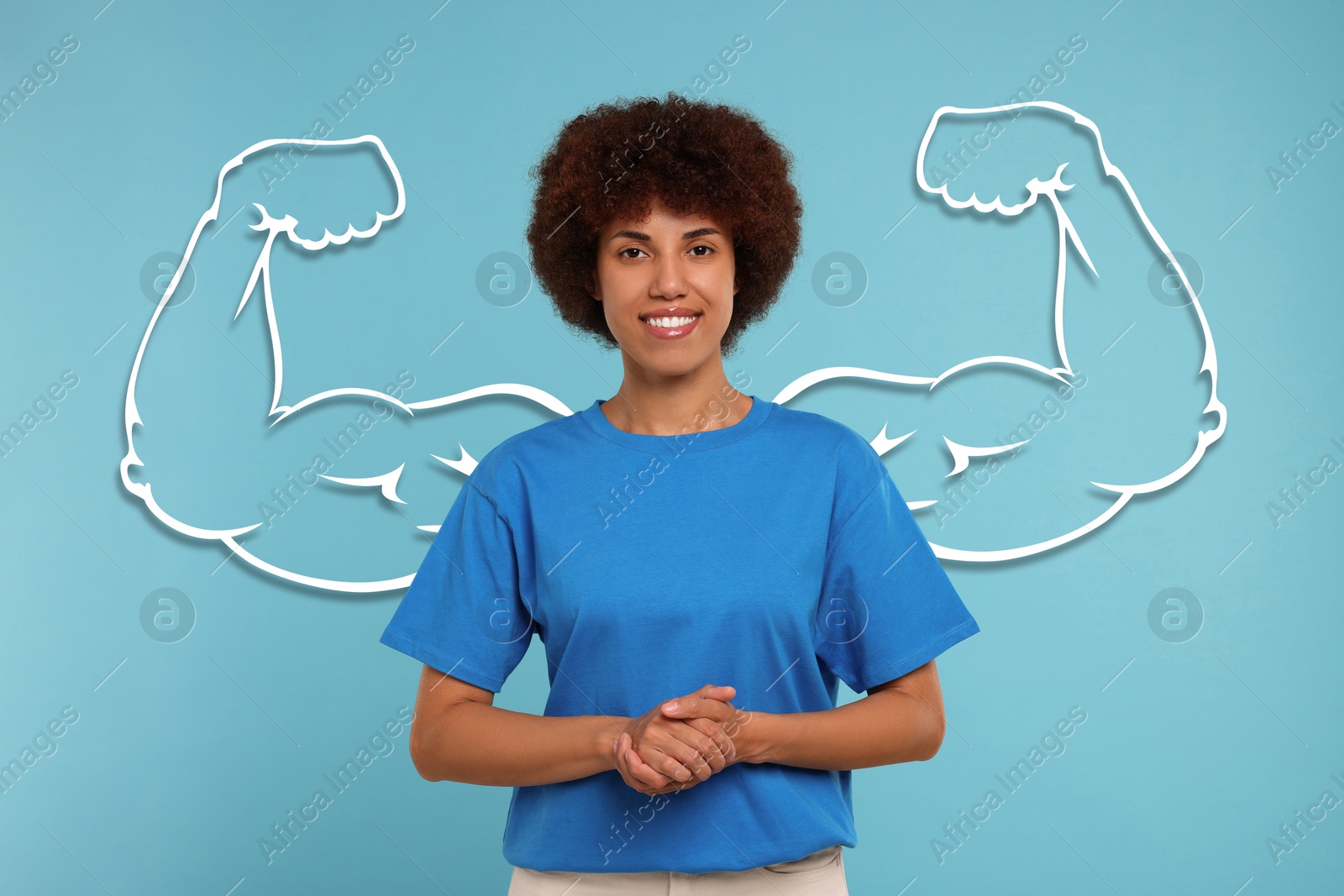 Image of Beautiful woman with drawing of strong arms behind her on light blue background