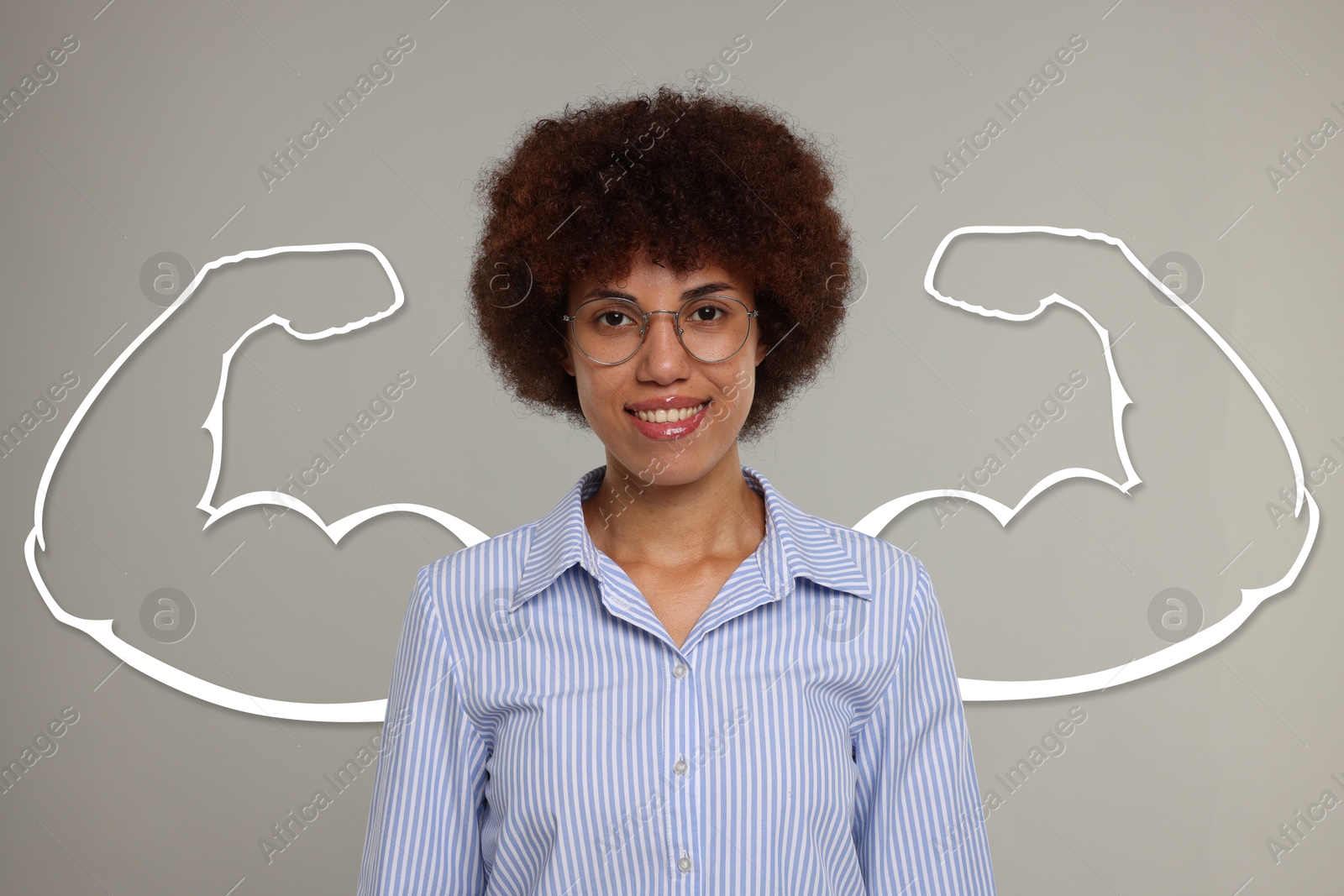 Image of Beautiful woman with drawing of strong arms behind her on grey background