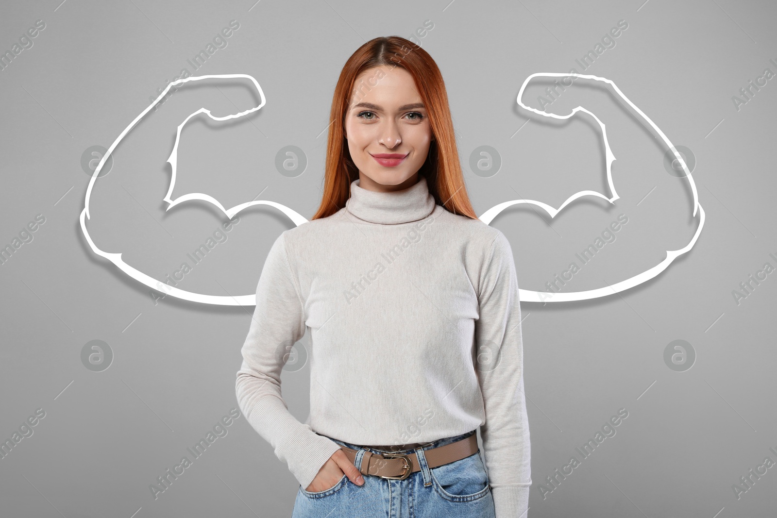 Image of Confident beautiful woman with drawing of strong arms behind her on grey background