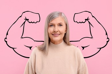 Image of Beautiful mature woman with drawing of strong arms behind her on pink background