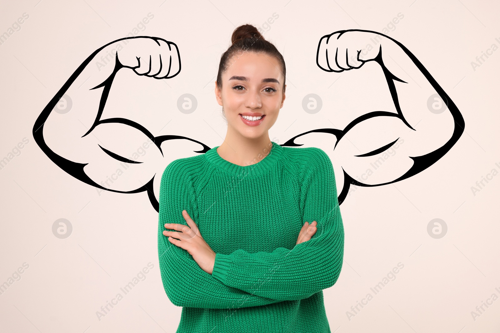 Image of Confident beautiful woman with drawing of strong arms behind her on light grey background