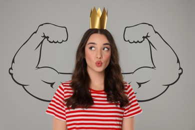 Image of Beautiful woman wearing golden crown on grey background with drawing of strong arms behind her