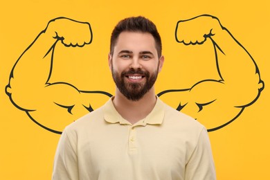 Image of Handsome young man with drawing of strong arms behind him on orange background