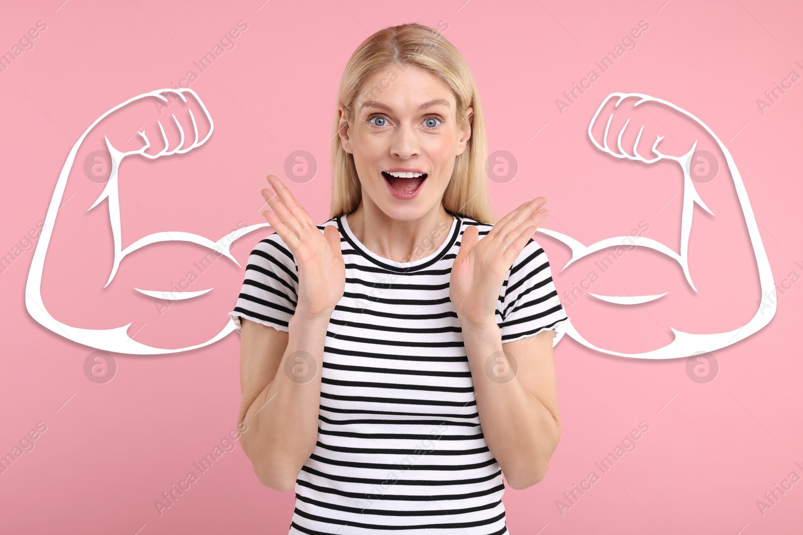 Image of Surprised beautiful woman with drawing of strong arms behind her on pink background