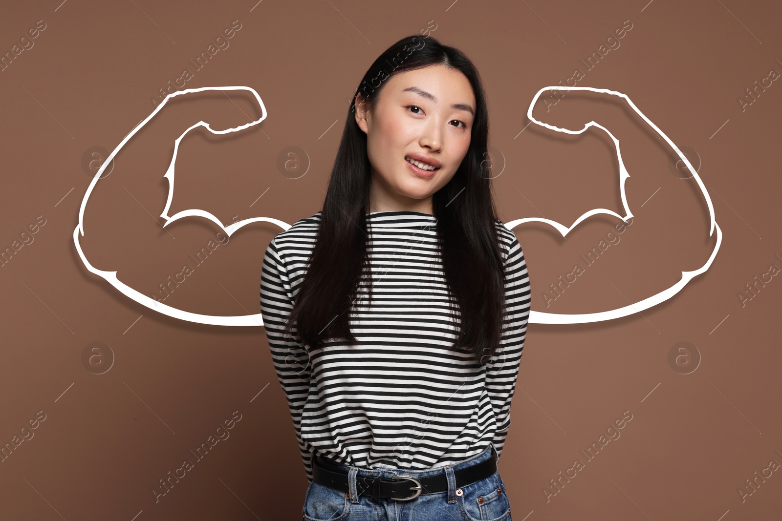 Image of Beautiful woman with drawing of strong arms behind her on brown background