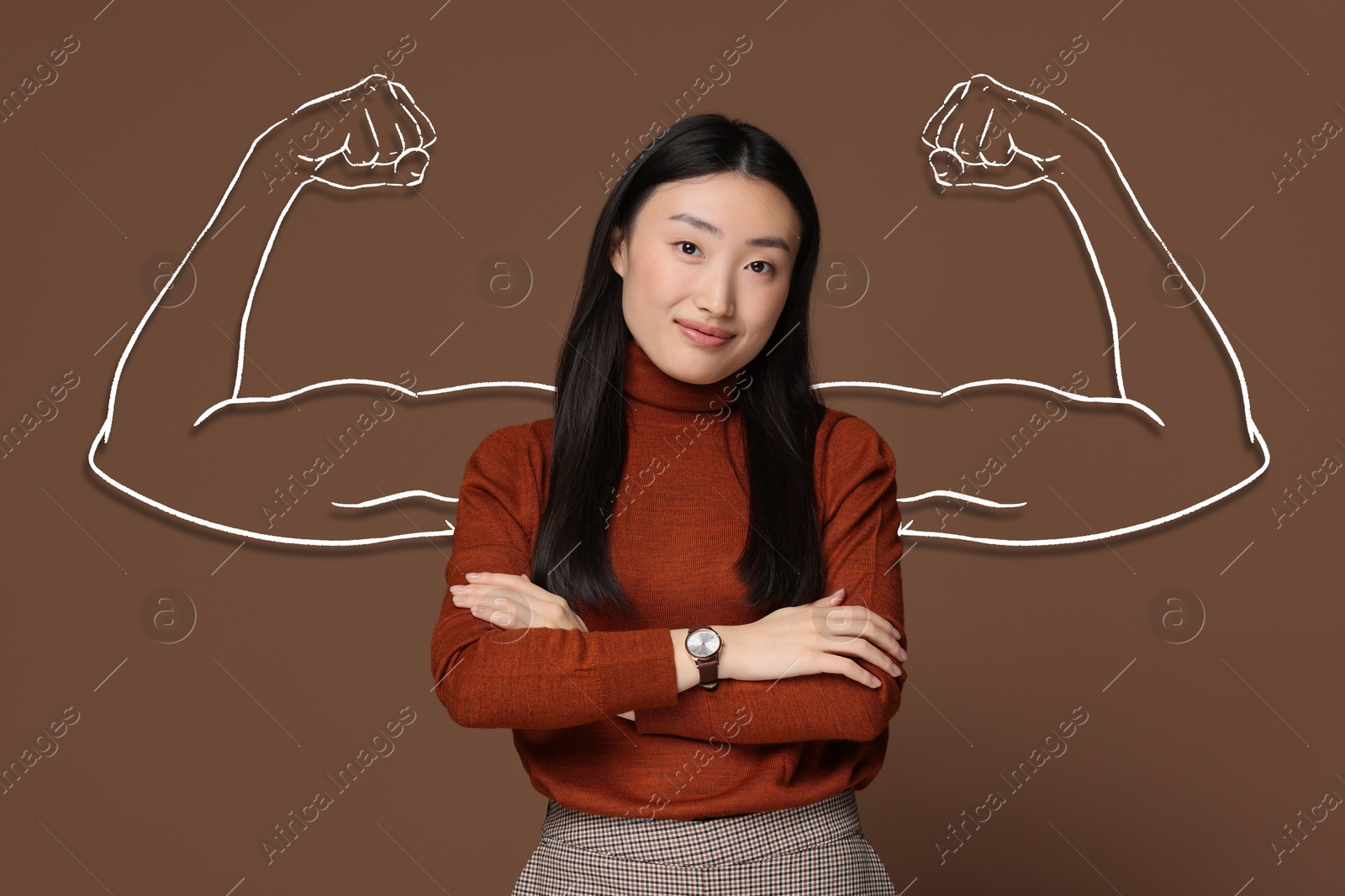 Image of Confident beautiful woman with drawing of strong arms behind her on brown background