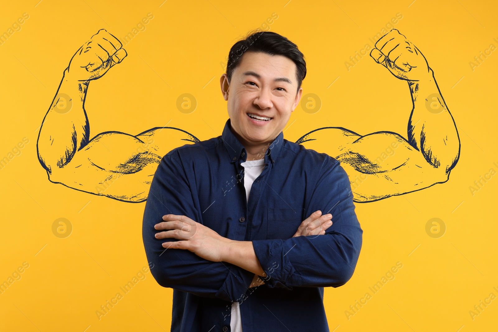 Image of Confident man with drawing of strong arms behind him on orange background