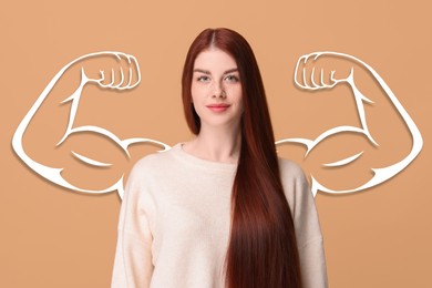 Image of Beautiful young woman with drawing of strong arms behind her on dark beige background