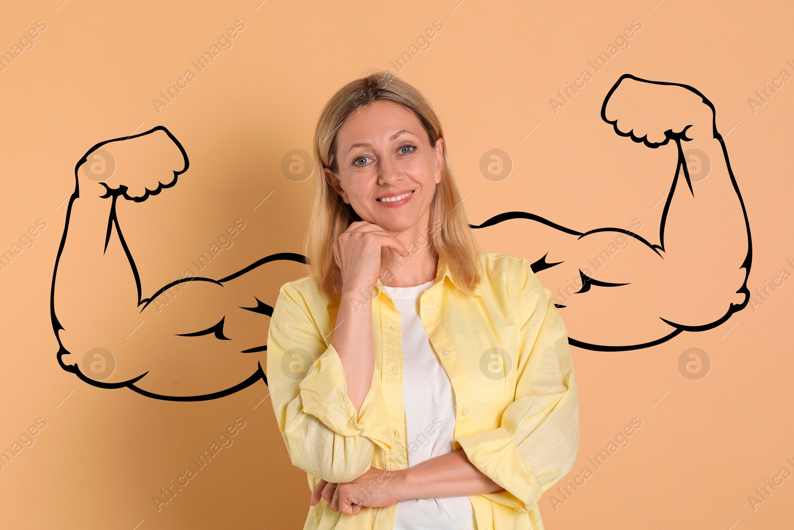 Image of Beautiful woman with drawing of strong arms behind her on dark beige background