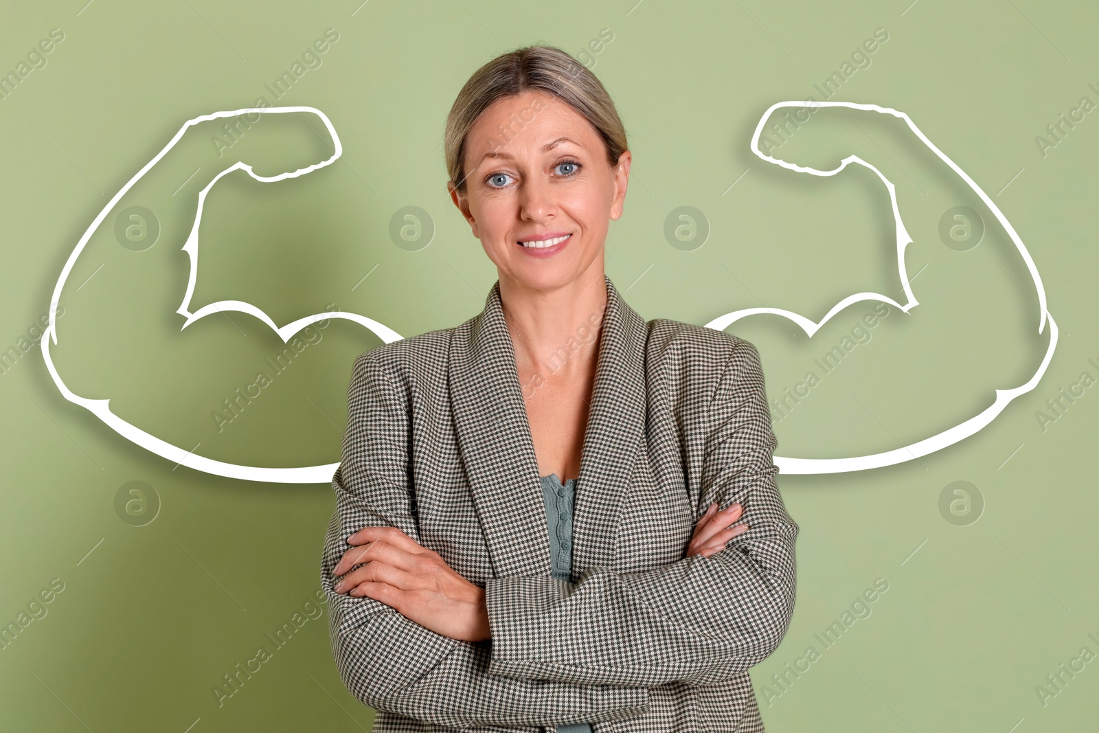 Image of Confident beautiful businesswoman with drawing of strong arms behind her on light green background