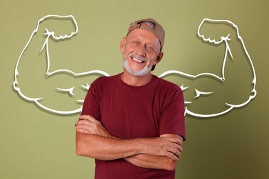 Image of Happy senior man with drawing of strong arms behind him on olive color background