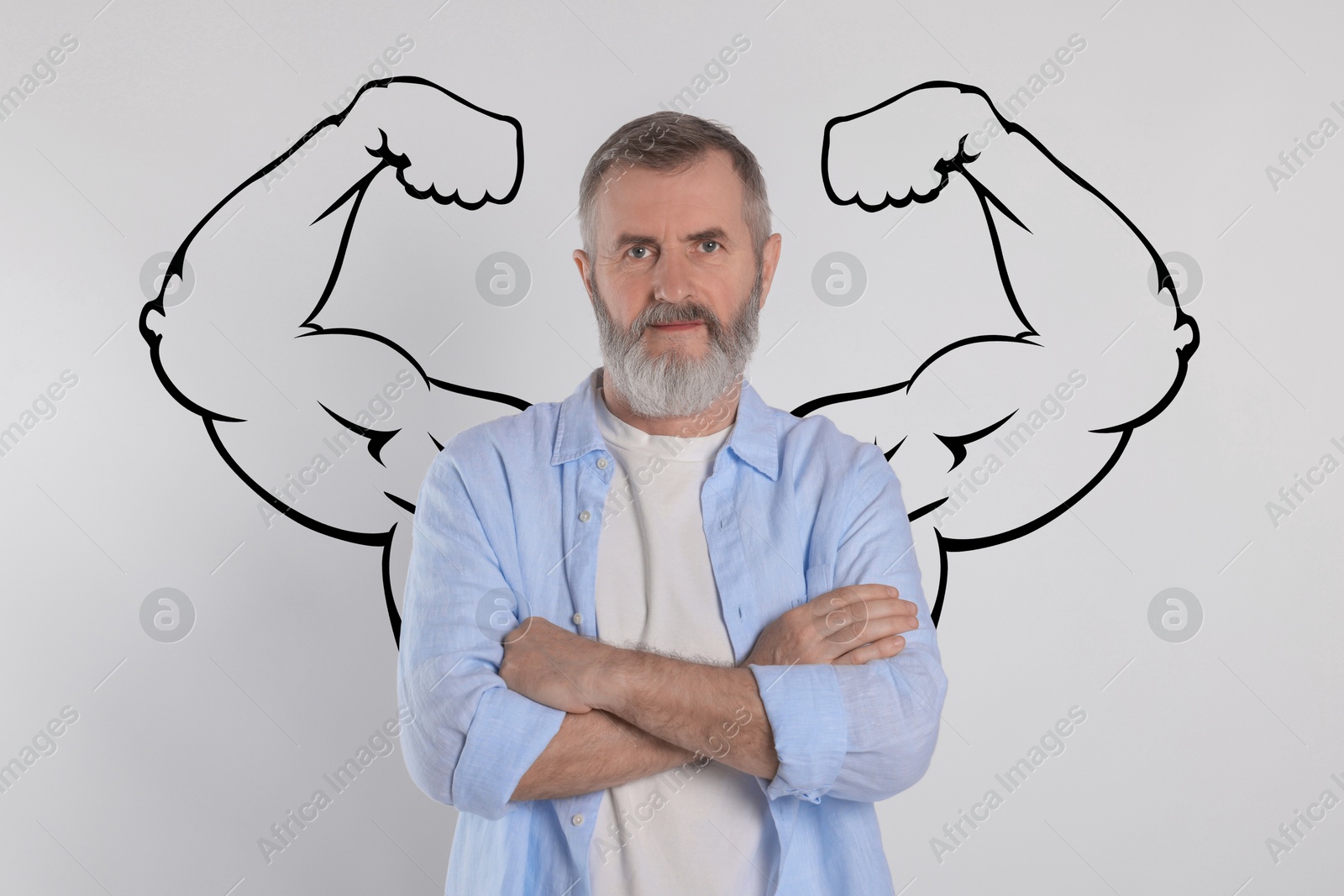 Image of Senior man with drawing of strong arms behind him on grey background