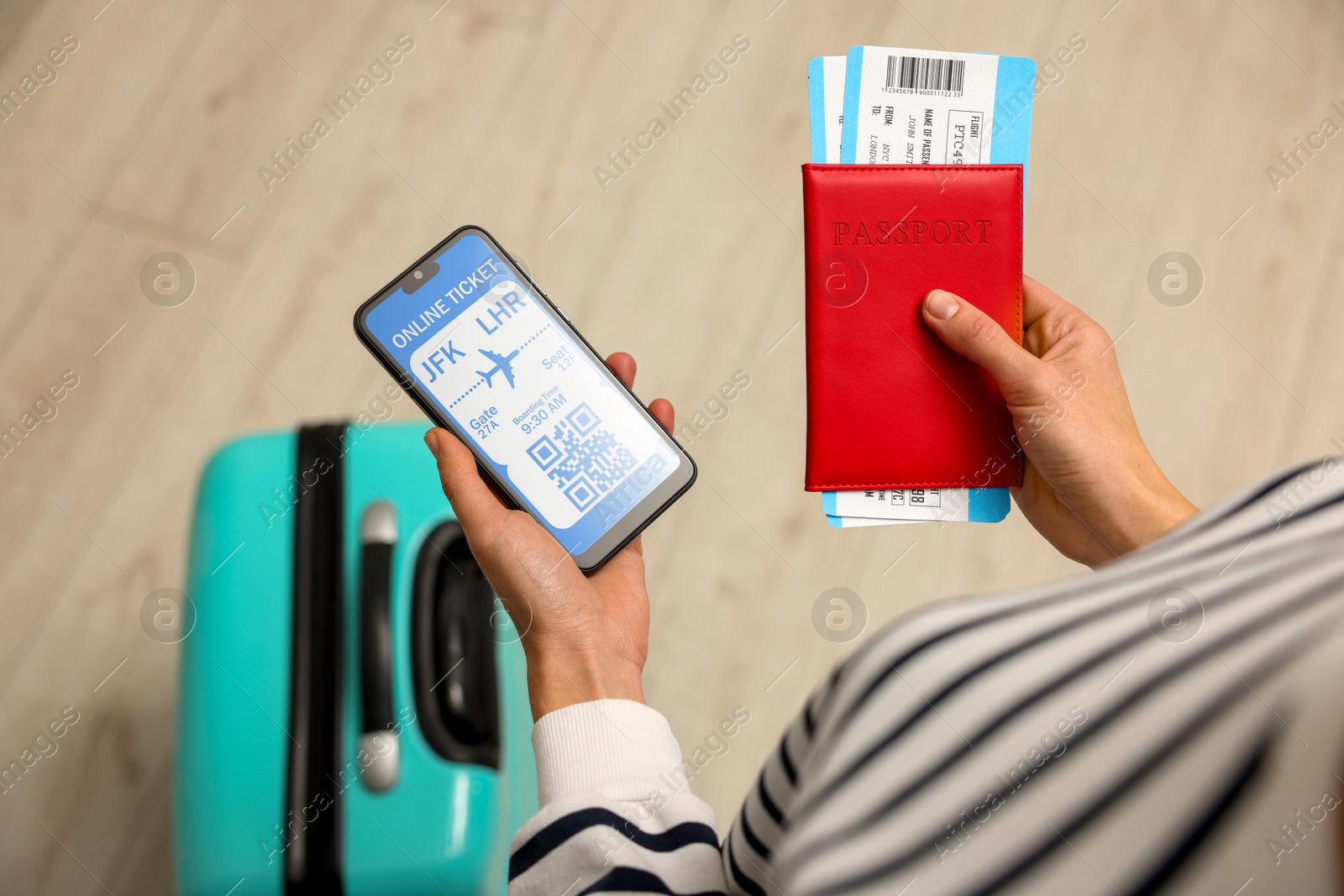 Image of Tourist with passport, flight tickets and mobile phone indoors, above view. Online ticket with QR code on device screen