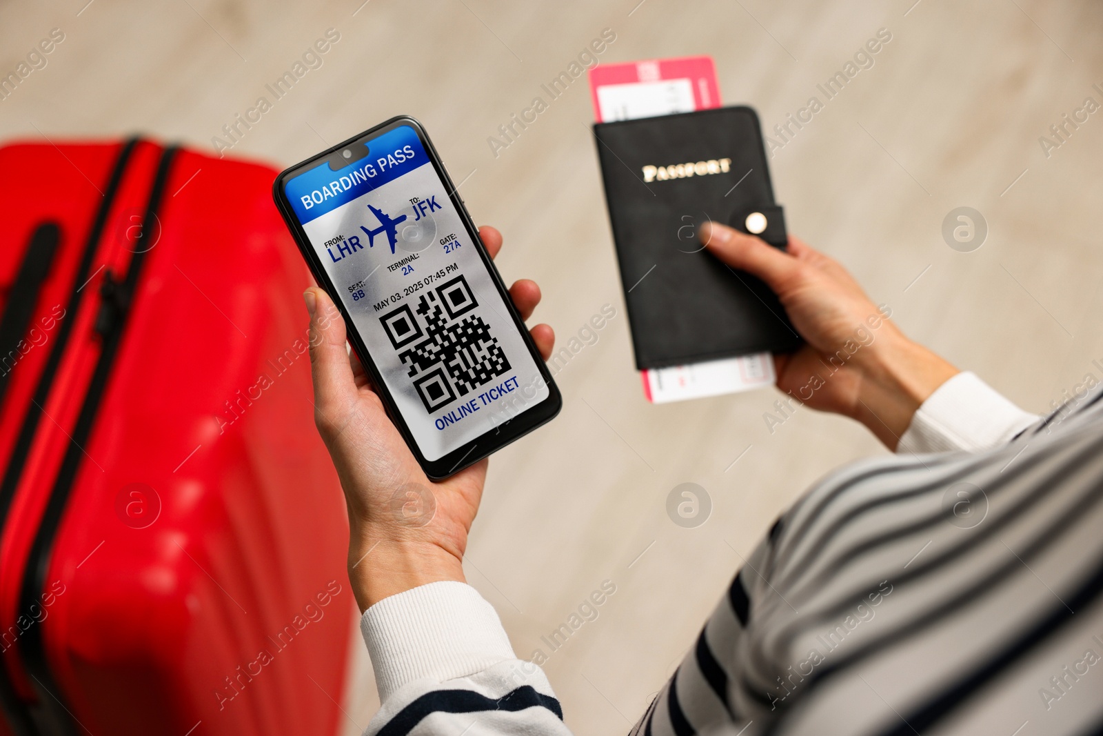 Image of Tourist with passport, flight ticket and mobile phone indoors, above view. Online ticket with QR code on device screen