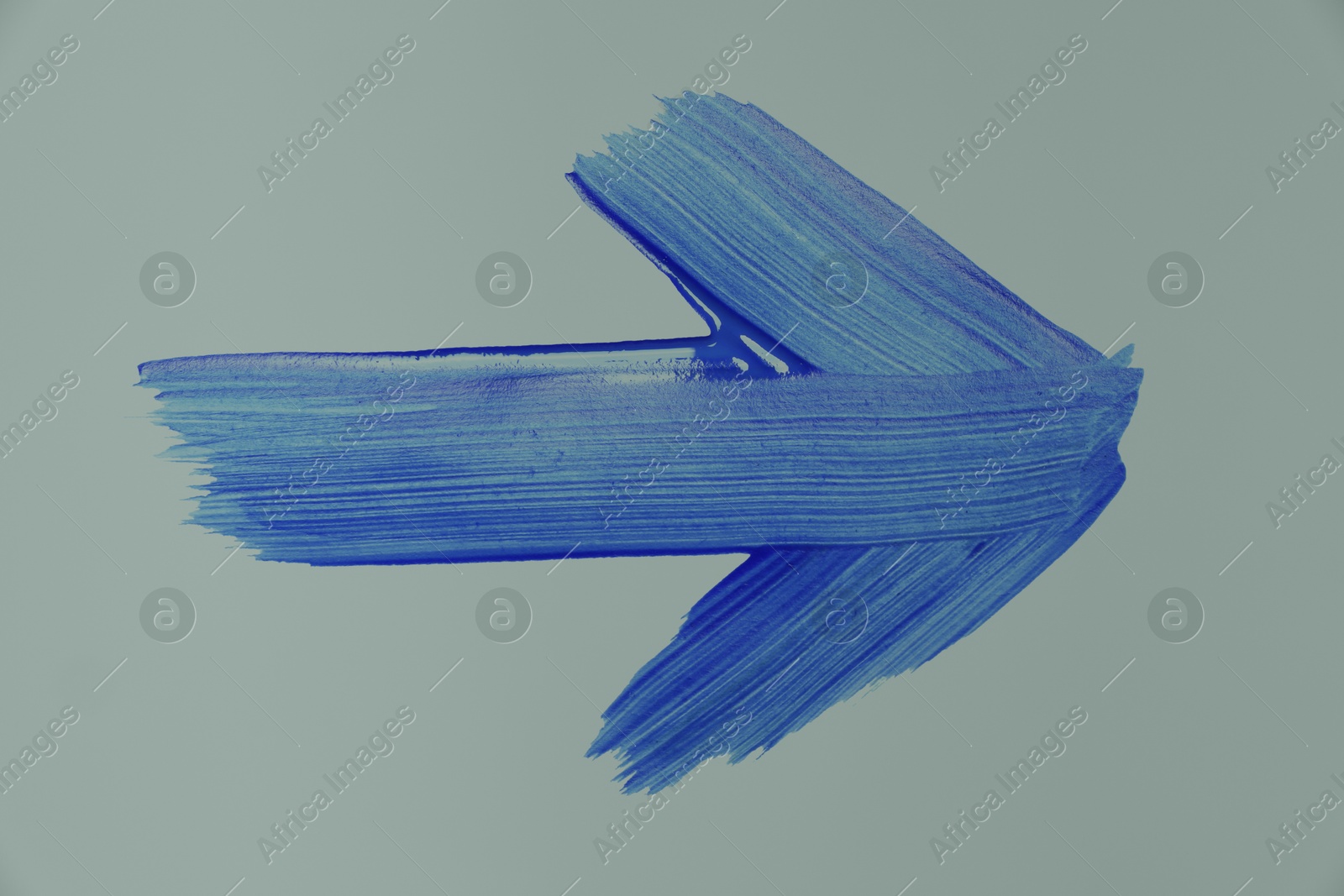 Image of One blue painted arrow on grey background