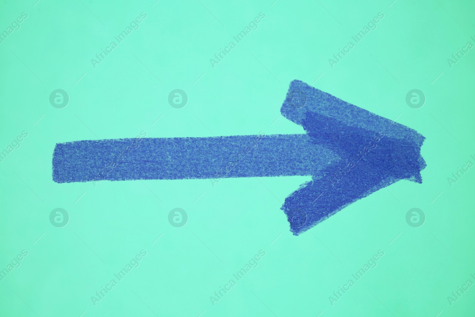 Image of One blue painted arrow on turquoise background