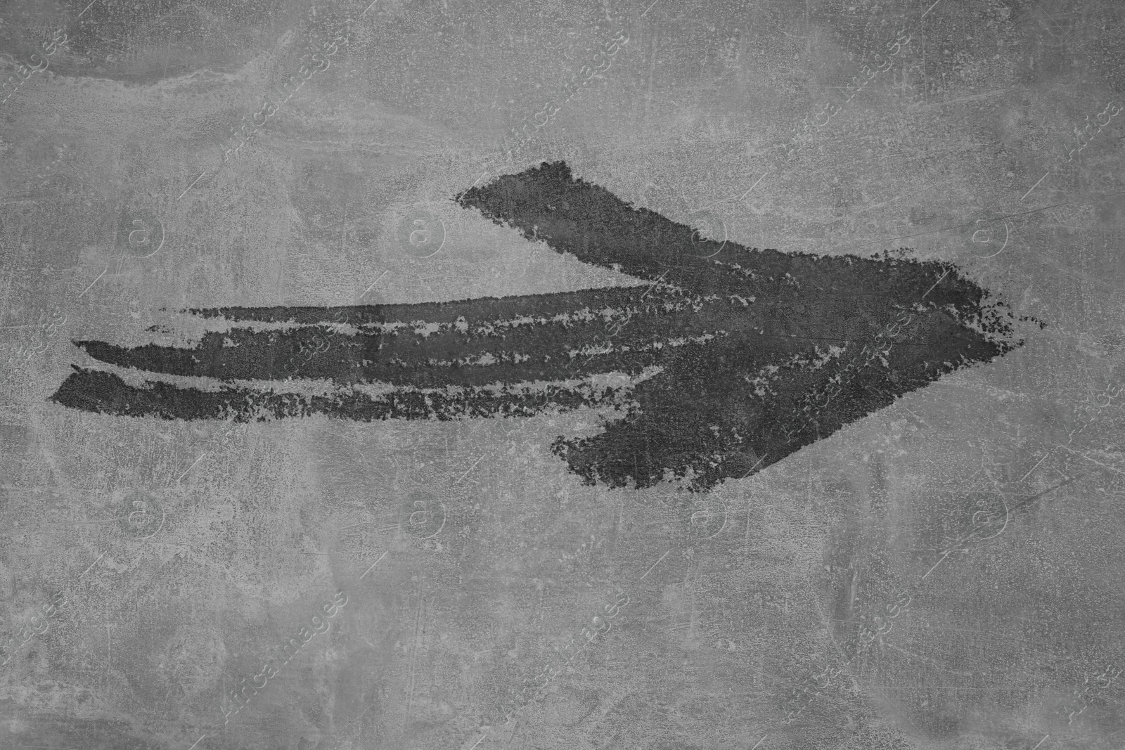 Image of One black painted arrow on grey background