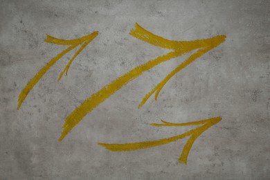 Image of Three golden painted arrows on grey background