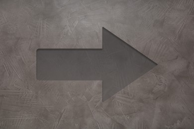 One arrow on grey textured background. Pointer