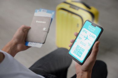 Image of Tourist with passport, flight tickets and mobile phone indoors, above view. Online ticket with QR code on device screen