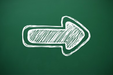 Image of One white arrow on green chalkboard. Pointer