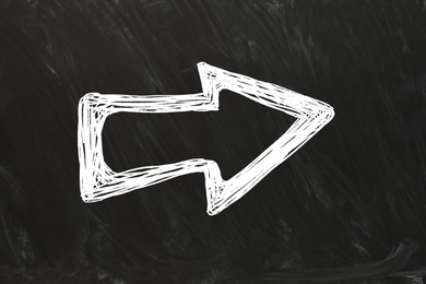 Image of One white arrow on black chalkboard. Pointer