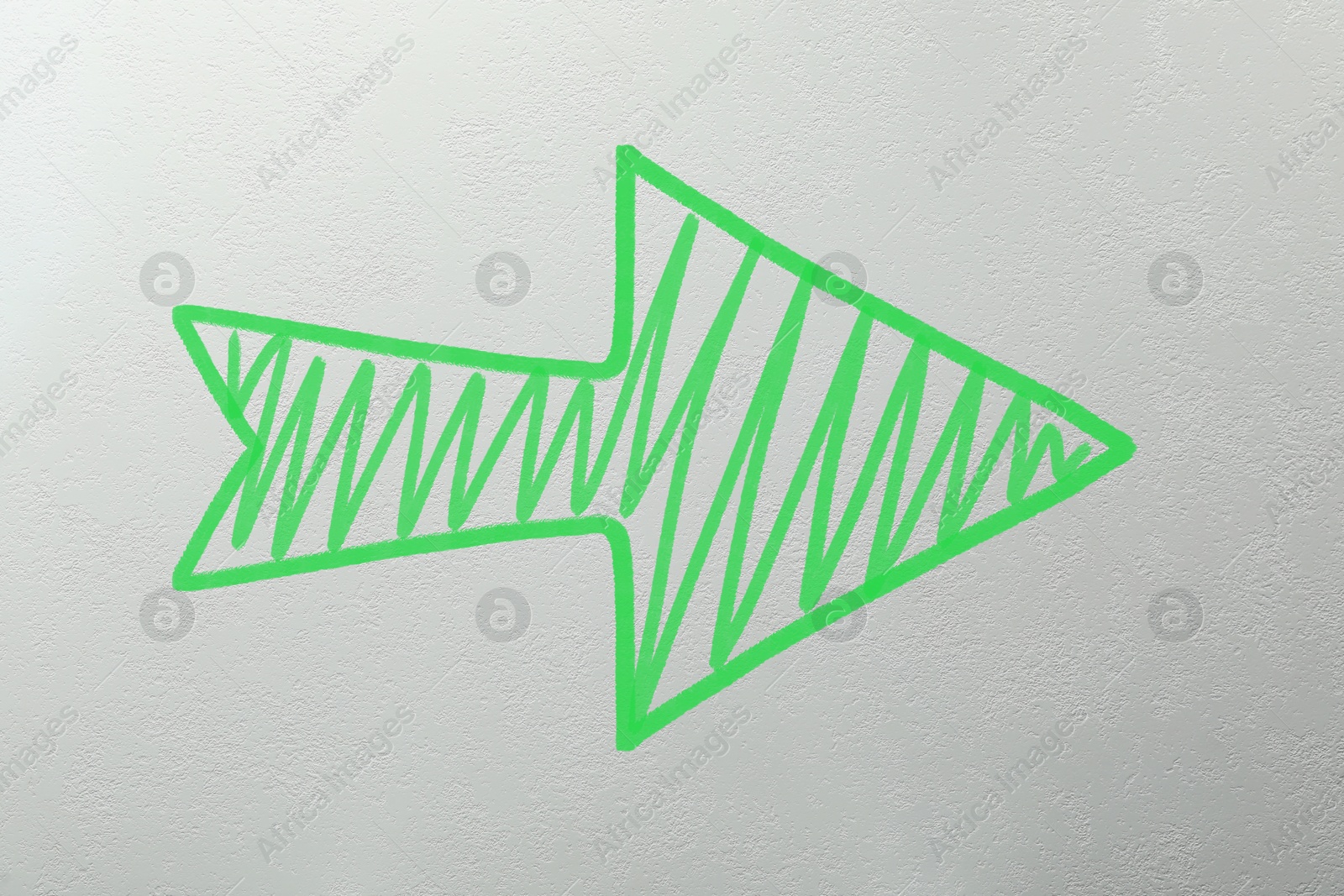 Image of One green arrow on light grey textured background. Pointer