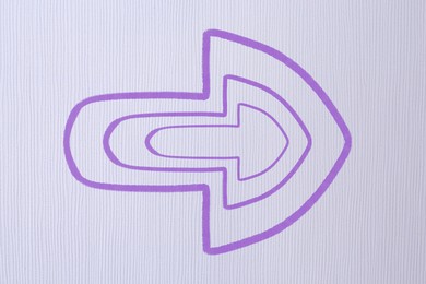 Image of One violet arrow on light grey textured background. Pointer