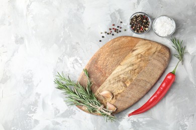 Photo of Cutting board with spices on grey textured table, flat lay. Space for text