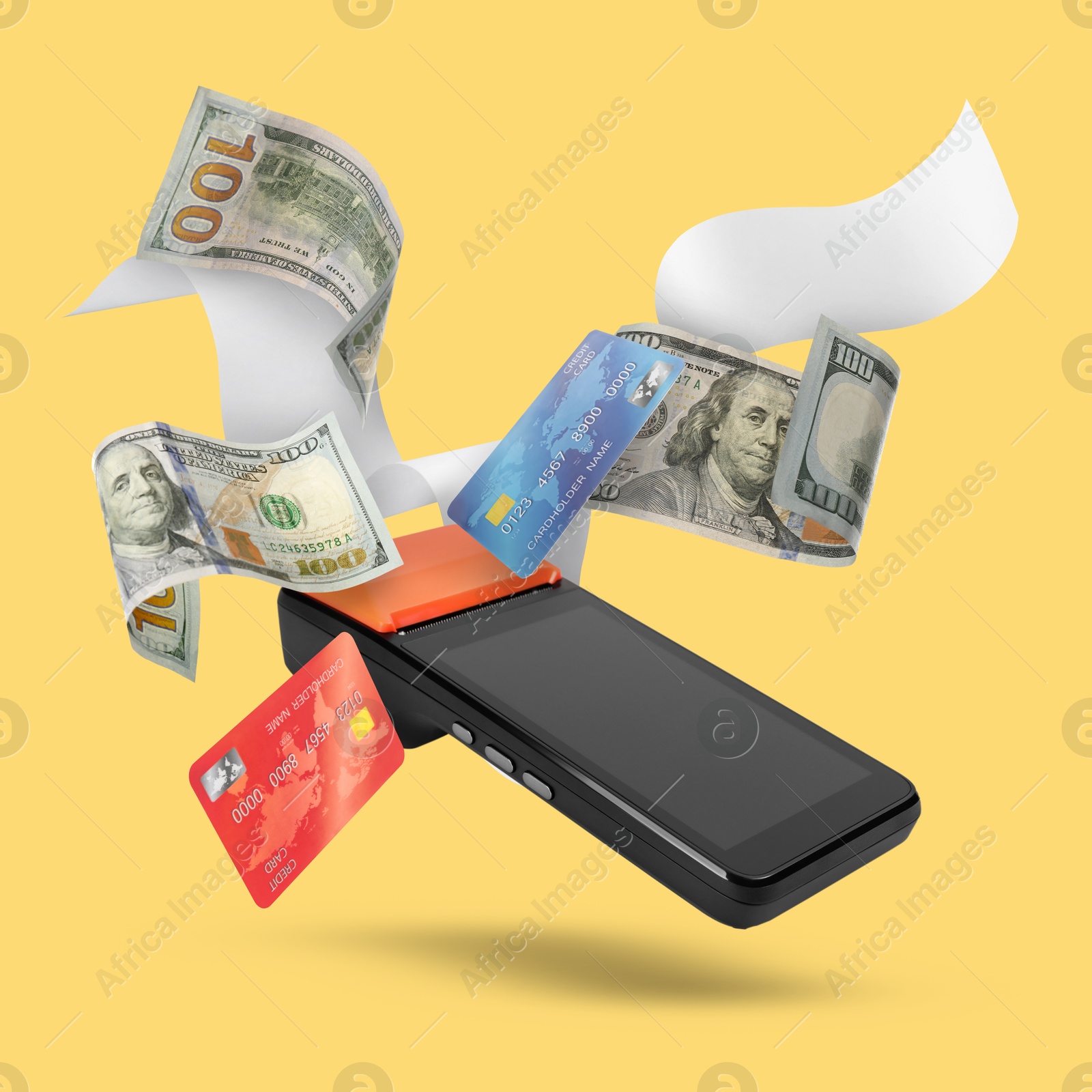 Image of Payment terminal, bank cards, dollars and receipt in air on yellow background