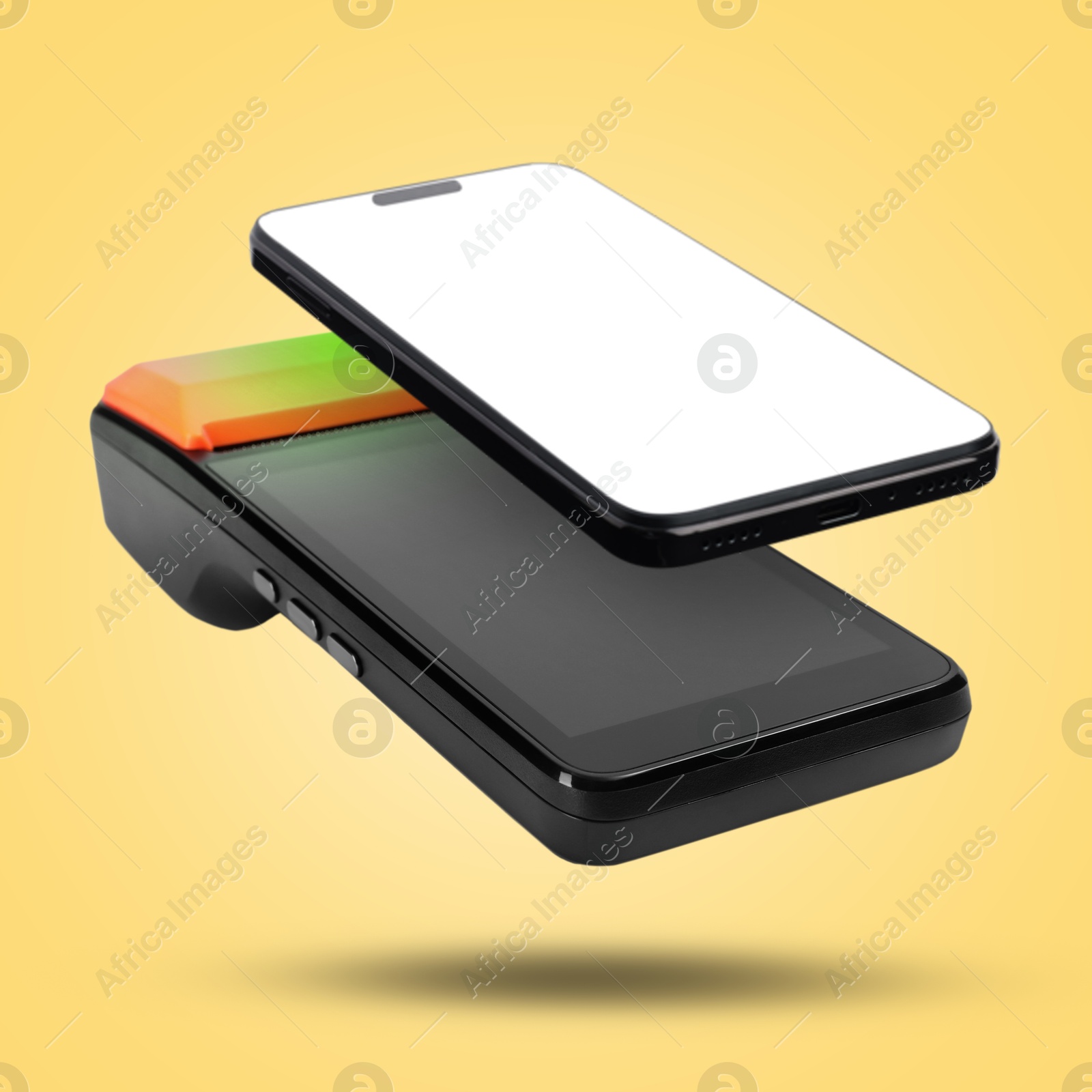 Image of Payment terminal and mobile phone in air on yellow background