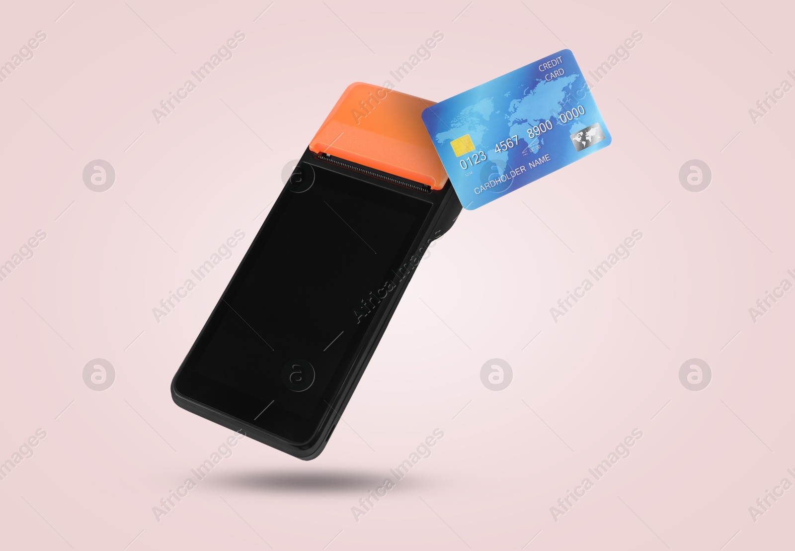 Image of Payment terminal and credit card in air on pink background