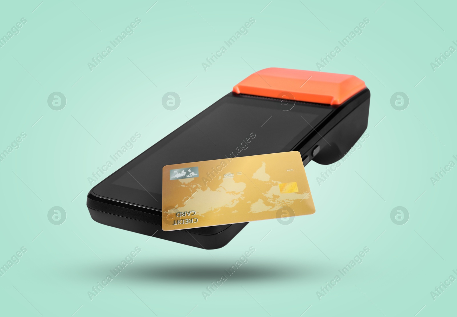 Image of Payment terminal and credit card in air on turquoise background