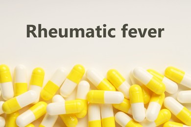 Image of Rheumatism. Pills and word Rheumatic Fever on white background, top view