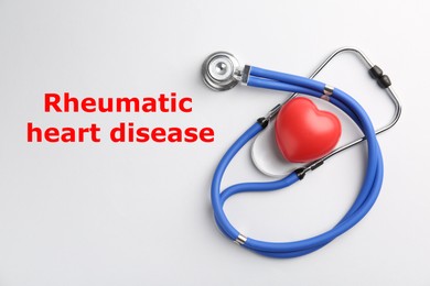 Image of Rheumatism. Stethoscope, red heart and words Rheumatic Heart Disease on white background, top view