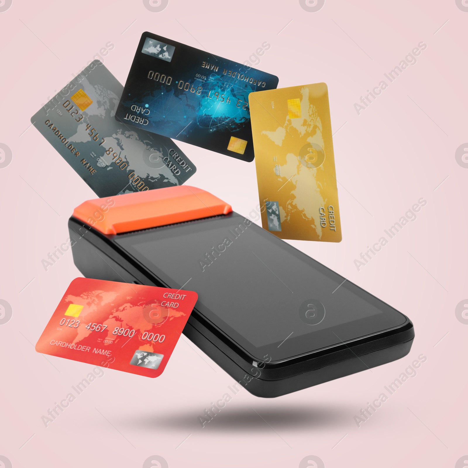 Image of Payment terminal and bank cards in air on pink background