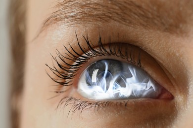 Image of Hypnosis. Hypnotic smoke in woman's eye, closeup