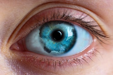 Image of Hypnosis. Hypnotic clouds in woman's eye, closeup