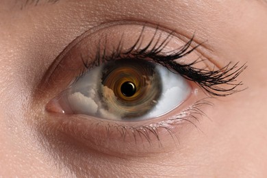 Image of Hypnosis. Hypnotic spiral and clouds in woman's eye, closeup