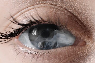 Image of Hypnosis. Hypnotic smoke in woman's eye, closeup